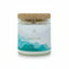 Candle jar with cork lid labeled 'Gratitude' on a white background