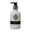 White bottle of Vanilla Cardamom wash with a black label on a light surface.